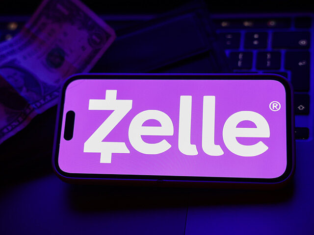 A laptop keyboard, a banknote, a wallet and Zelle logo displayed on a phone screen are see