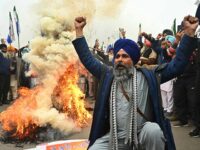 Farmers shout slogans as they burn an effigy of India's Prime Minister Narendra Modi durin