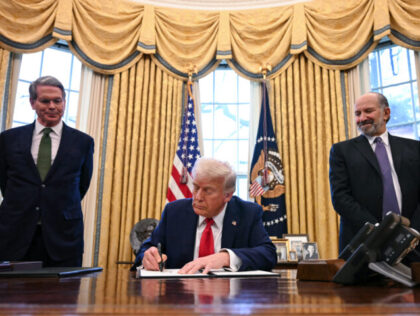 US President Donald Trump, alongside Secretary of Treasury Scott Bessent (L) and Secretary