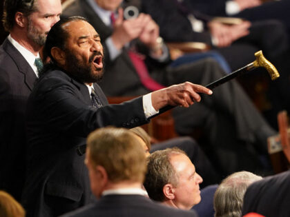 US Representative Al Green (D-TX) (L) disrupts US President Donald Trump as he addressed t