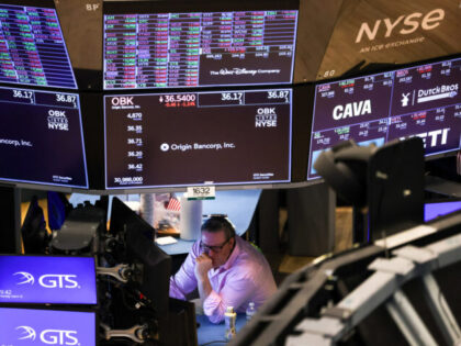 TOPSHOT - A trader works on the floor of the New York Stock Exchange (NYSE) at the opening