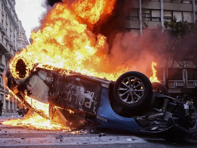 BUENOS AIRES, ARGENTINA - MARCH 12: Protesters set fire to a police car outside the Nation
