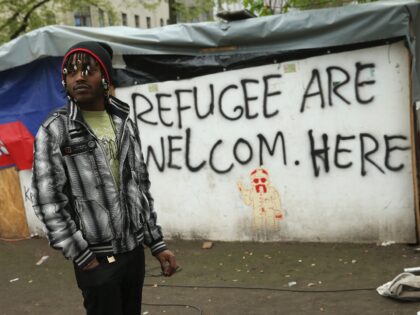 BERLIN, GERMANY - APRIL 08: A refugee from Niger stands by near huts that were being torn