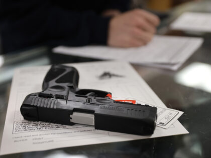 A customer purchases a gun at Freddie Bear Sports on April 08, 2021 in Tinley Park, Illino