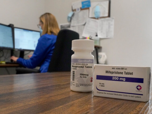 A Nurse Practitioner works in an office at a Planned Parenthood clinic where she confers v