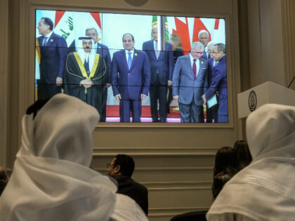 Journalists watch a screen displaying Egyptian President Abdel Fattah el-Sissi, center, wi