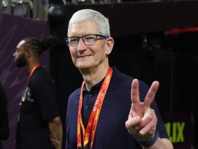 Tim Cook CEO of Apple flashes the V for victory