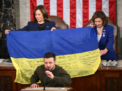 Ukraine's President Volodymyr Zelensky speaks after giving a Ukrainian national flag