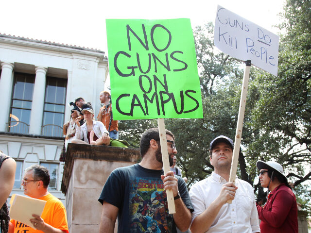 ** EDS: NOTE GRAPHIC CONTENT IN IMAGE ** Students holds signs and sex toys as they protest