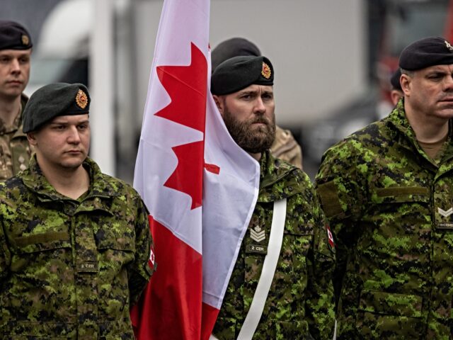Canadian soldiers are seen taking part in a ceremony to mark the 25th anniversary of Polan