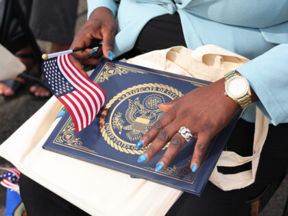 People participate in a Naturalization Ceremony at Liberty State Park on September 17, 202