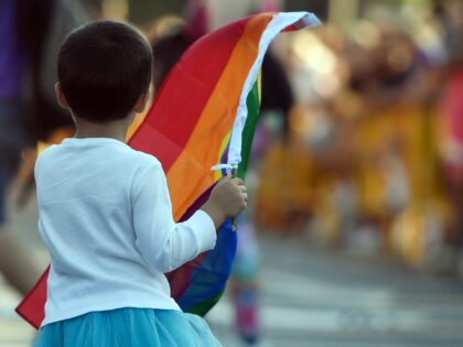 A child waves a rainbow flag during the WorldPride 2017 parade in Madrid on July 1, 2017.