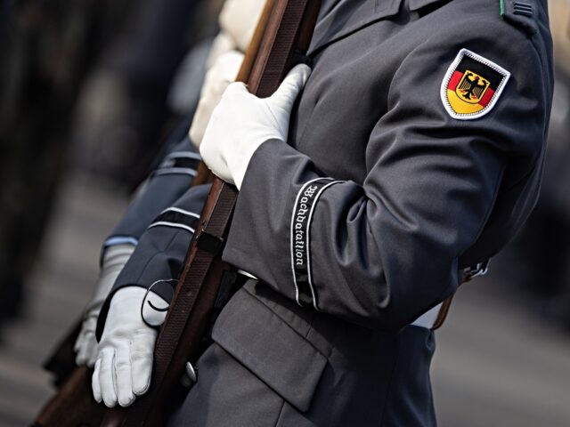 germany soldiers 14 March 2025, Berlin: A soldier of the guard battalion holds a rifle during the event. Th