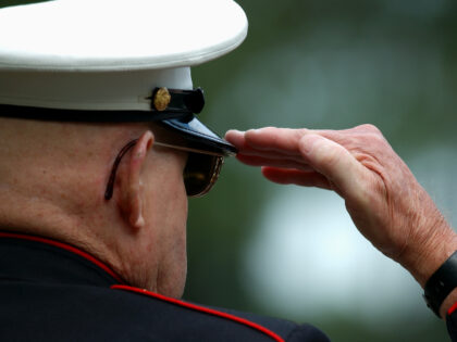 older Marine saluting