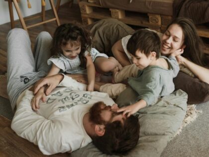 A Family Lying on the Floor Enjoying their Bonding