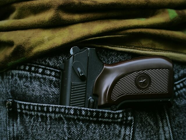pexels-darya-grey_owl-132130036-16778234 Close-up of Gun in Jeans Pocket