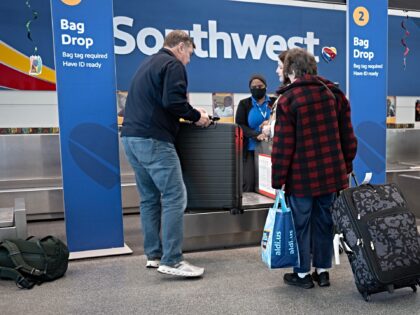 CHICAGO, ILLINOIS - FEBRUARY 18: Passengers check in for Southwest Airlines flights at Chi