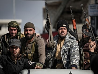 10 March 2025, Syria, Jableh: Members of the Syrian security forces patrol a street in Jab