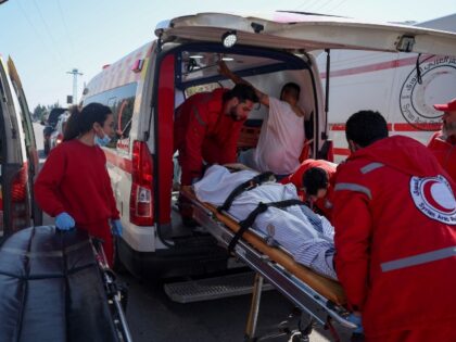 Syrian Red Crescent members evacuate wounded civilians who took refuge from violence in th