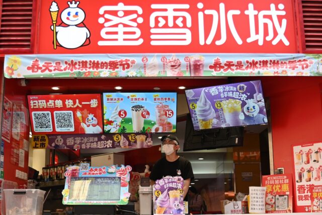 An employee waits for customers at a Mixue Ice Cream & Tea store in Hong Kong on March 26,