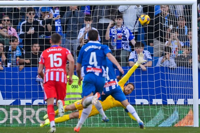 Atletico Madrid's Slovenian goalkeeper #13 Jan Oblak (R) fails to stop Javi Puado's penalt