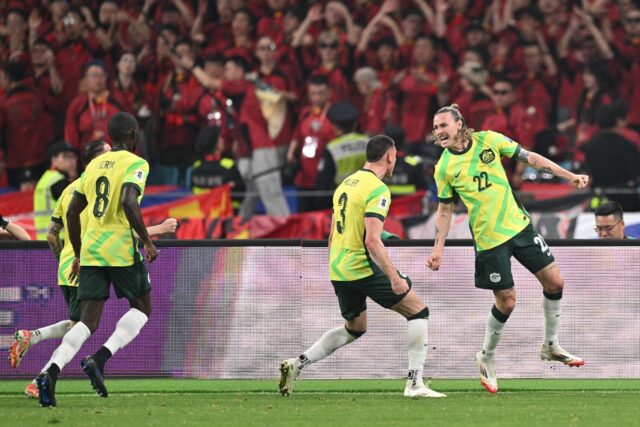 Australia's Jackson Irvine (R) celebrates with teammates after scoring