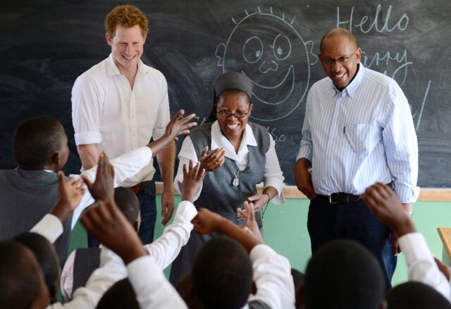 Britain's Prince Harry, flanked by Sister Victoria Mota, and Prince Seeiso, the younger br