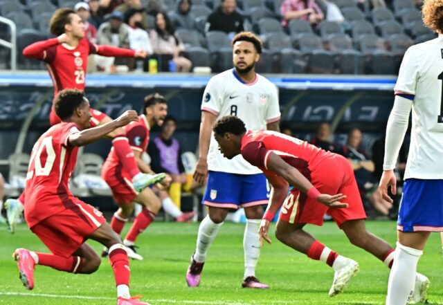 Canadian forward Jonathan David (right) wheels away after scoring his team's winning goal