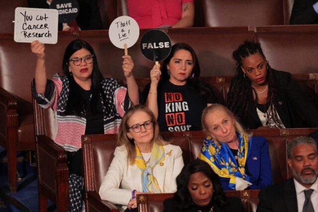 Democrats held up signs to as US President Donald Trump delivered his speech to Congress,