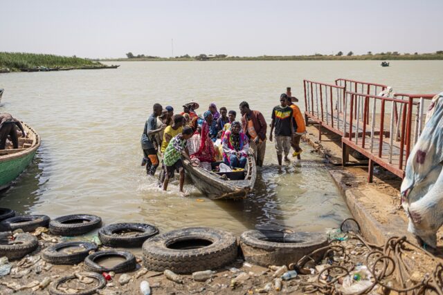 A dug-out canoe brings people across the Senegal river from Mauritania to Rosso