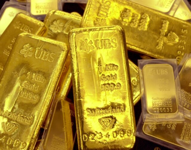 Gold hit another record high as traders flood into safe havens to shelter from market unce