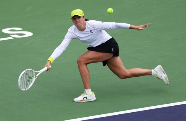 Iga Swiatek of Poland plays a forehand on the way to a quarter-final victory over China's