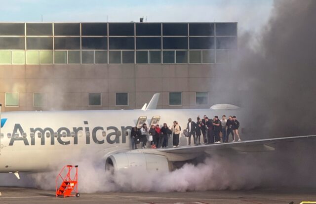 This image courtesy of Branden Williams shows passengers standing on the wing of an Americ