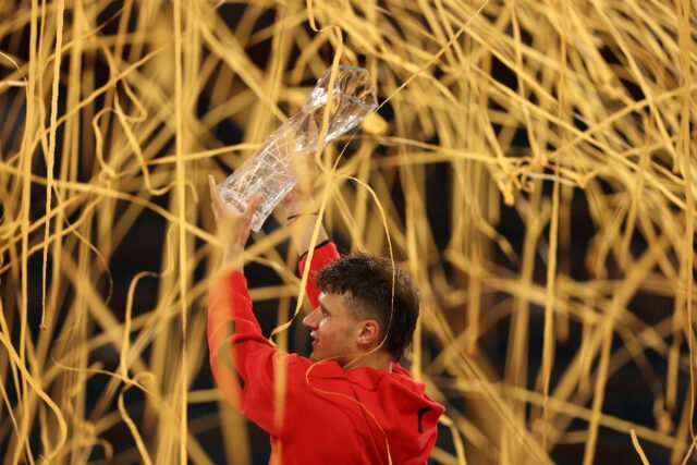 Jakub Mensik of the Czech Republic lifts the championship trophy after defeating Novak Djo