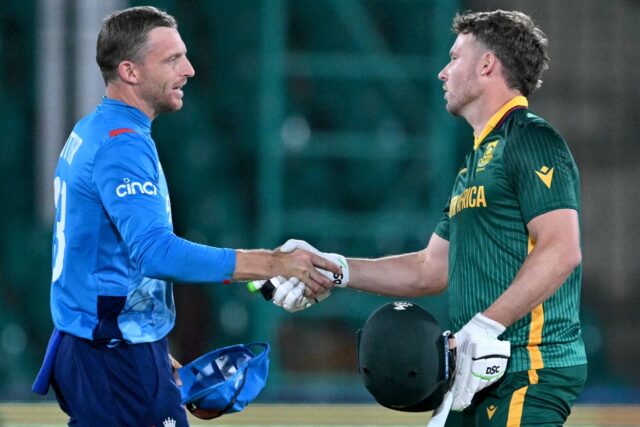 Jos Buttler (L) shakes hands with South Africa's David Miller after England suffered a hea