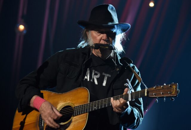 Musician Neil Young, seen here performing onstage in Los Angeles, will open his upcoming E
