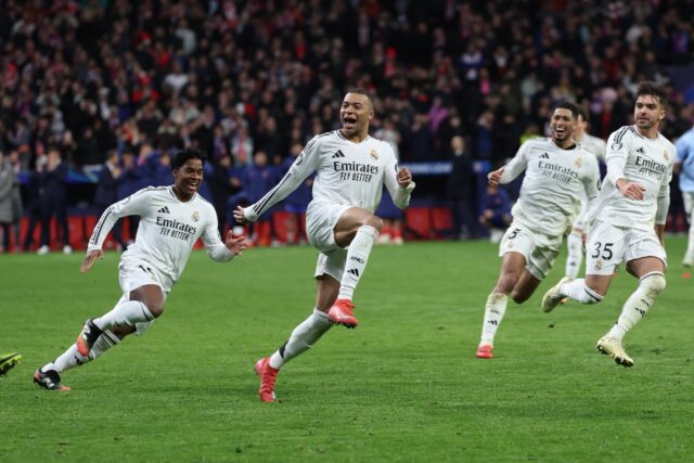 Real Madrid's French forward Kylian Mbappe (C) celebrates with team-mates after the shoot-