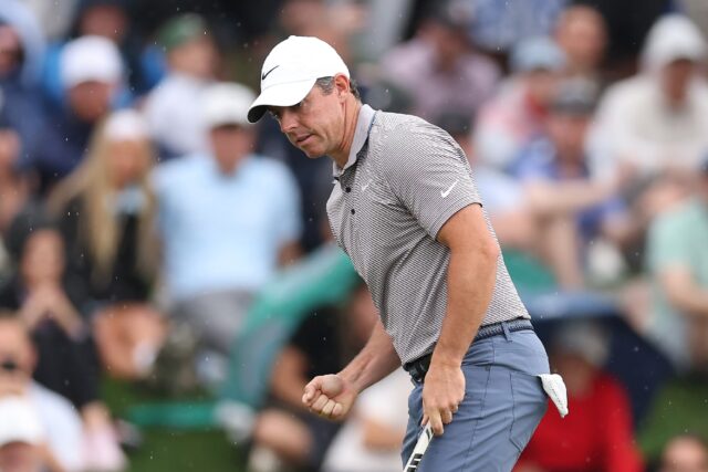 Rory McIlroy of Northern Ireland pumps his right fist after making a birdie putt at the 11