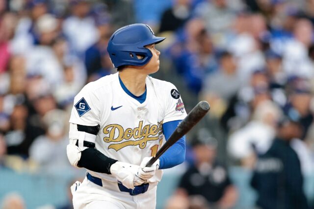 Shohei Ohtani of the Los Angeles Dodgers watches his home run in the seventh inning of a v