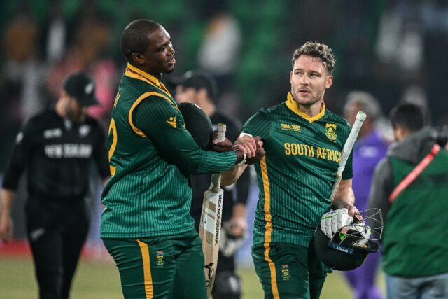 South Africa's David Miller (R) shakes hands with team-mate Lungi Ngidi after their side's