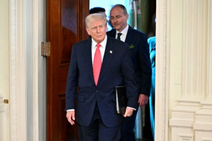 US President Donald Trump and Irish Prime Minister Micheal Martin (back) arrive for a St.