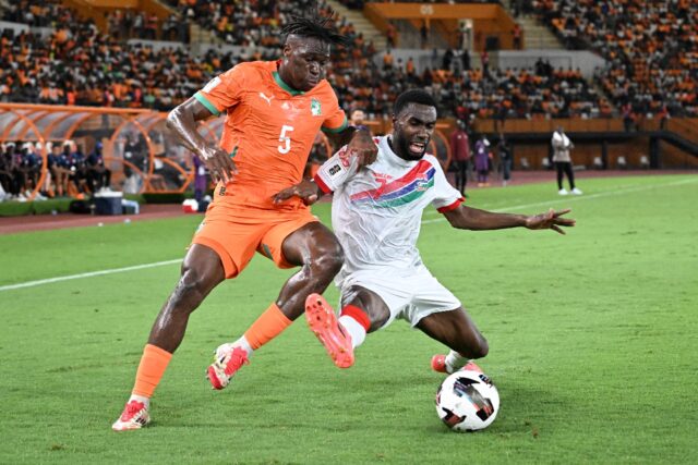 Wilfried Singo of Ivory Coast (L) and Alieu Fadera of Gambia fight for the ball in a 2026