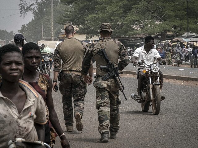 FILE - French army military instructors walk on one of the main roads in Tanguietan, north