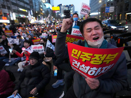 People shout slogans during a rally to celebrate after South Korea's Constitutional Court