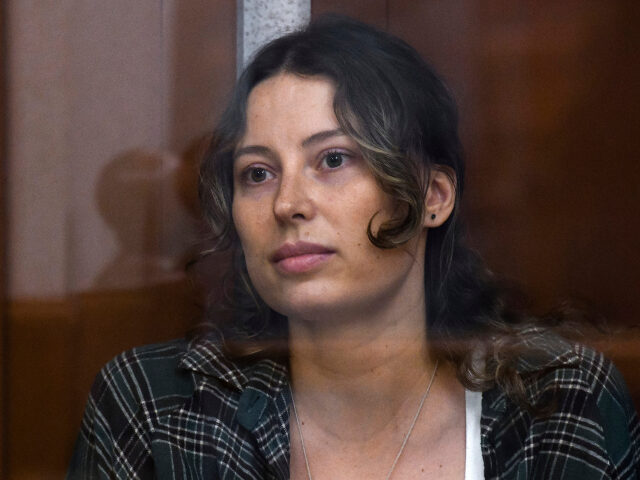 AP25100338852022 FILE - Ksenia Karelina, also known as Khavana sits in a glass cage in a court room in Yeka