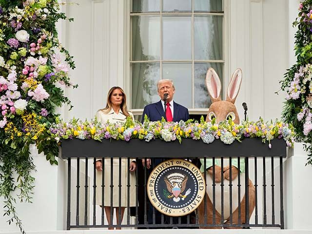 President Donald Trump and first lady Melania Trump stand on the Blue Room Balcony as they
