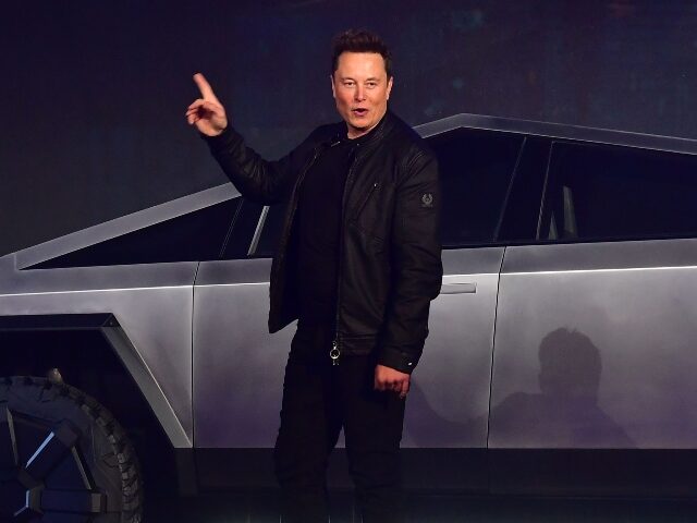 Elon Musk poses with his Cybertruck