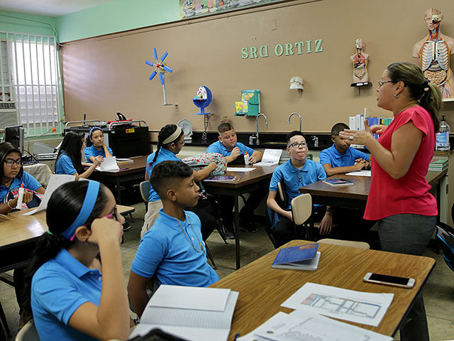 Counselor Isis Vega welcomes seventh-grade students at Rosa Costa Valdivieso, a public mid