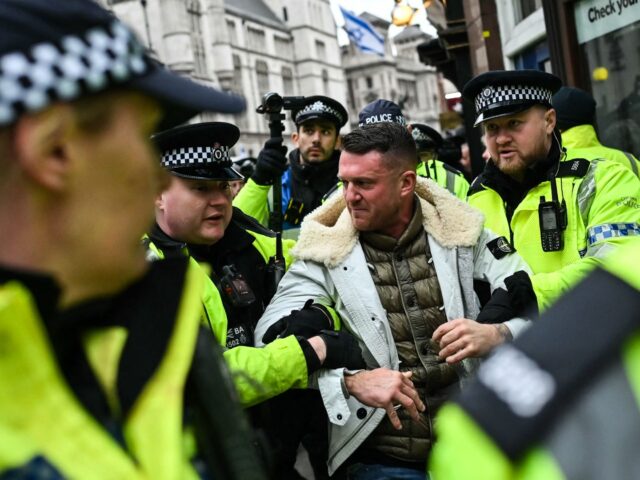 Metropolitan Police officers arrest British far-right activist Tommy Robinson during a dem