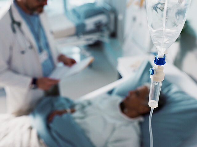 IV drip, healthcare and medicine with doctor and patient in hospital